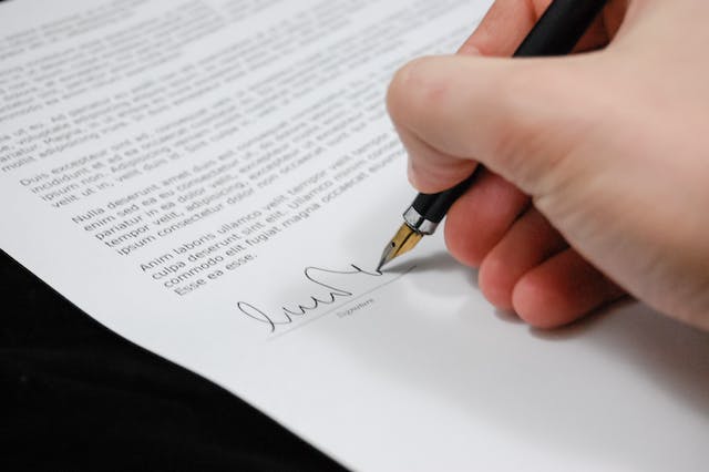 a-person-signing-documents